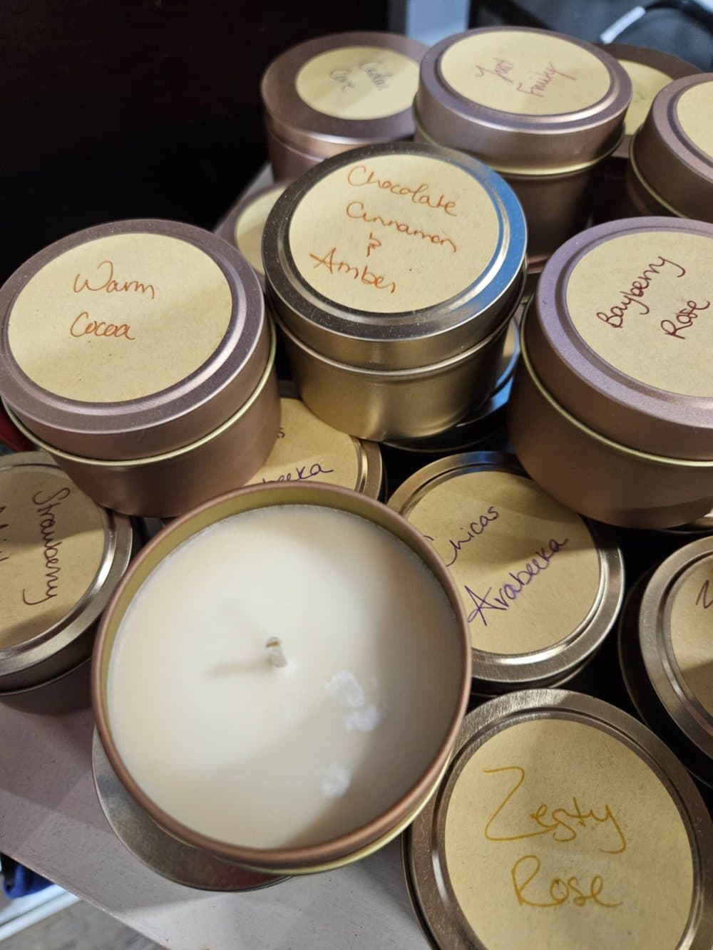 Hand-poured candles in tins